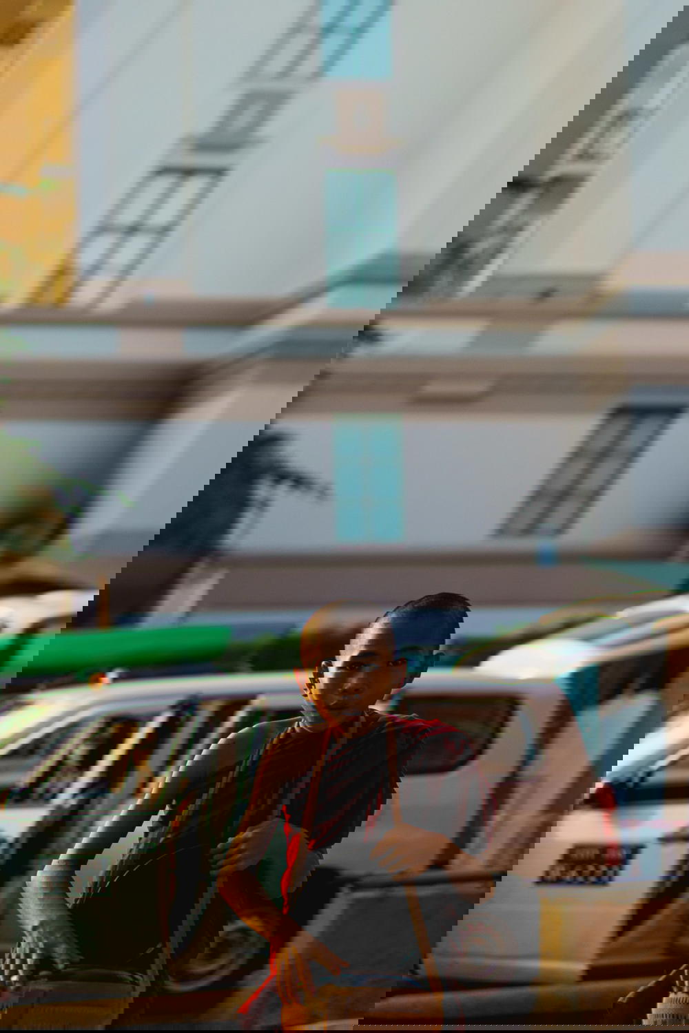 Young Burmese Buddhist monk carrying a bag and walking in Yangon Myanmar