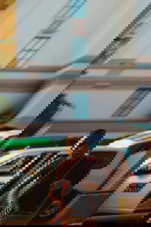 A young monk on a motorcycle in Myanmar (Burma), specifically in Yangon.