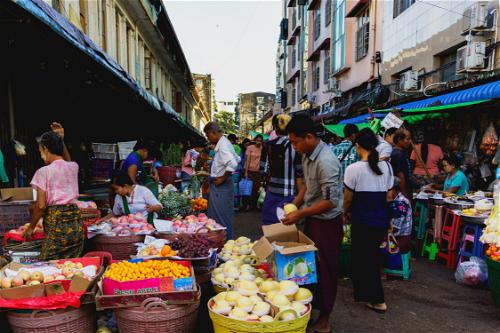 Street local market women selling fruits vegetables fish in Chinatown Yangon Myanmar Burma