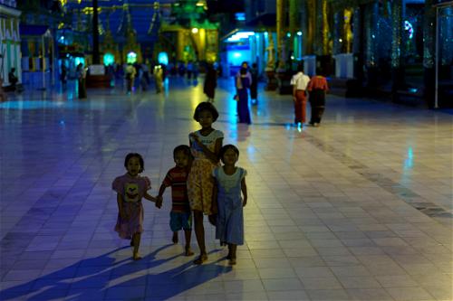 Local Burmese children at Shwedagon Pagoda night after dark, Yangon, Myanmar