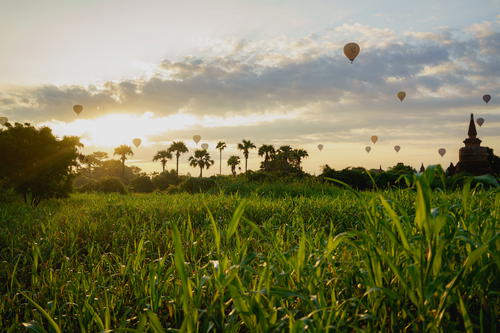 Sunrise at Bagan, Myanmar (Burma) with hot air balloons in the sky among pagodas