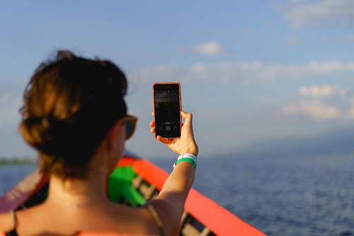 Woman taking selfie photo with Google Pixel phone at Inle Lake, Myanmar (Burma)