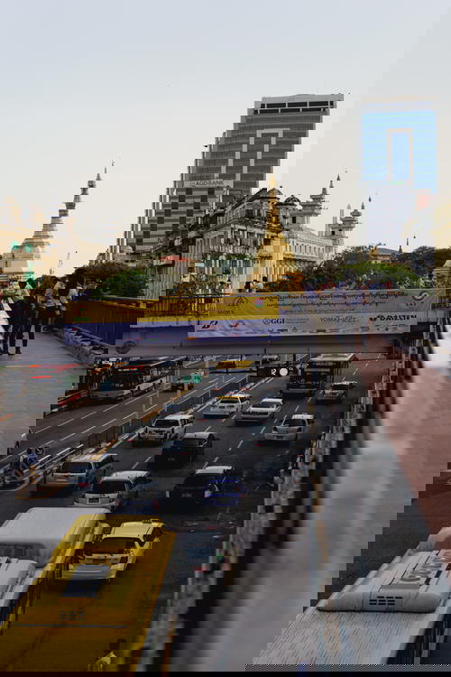 Pedestrian overpass walking bridge over busy road with view of Sule Pagoda Yangon Myanmar Burma