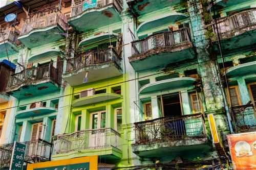 Colorful green teal turquoise homes and buildings typical architecture in Chinatown Yangon Myanmar Burma