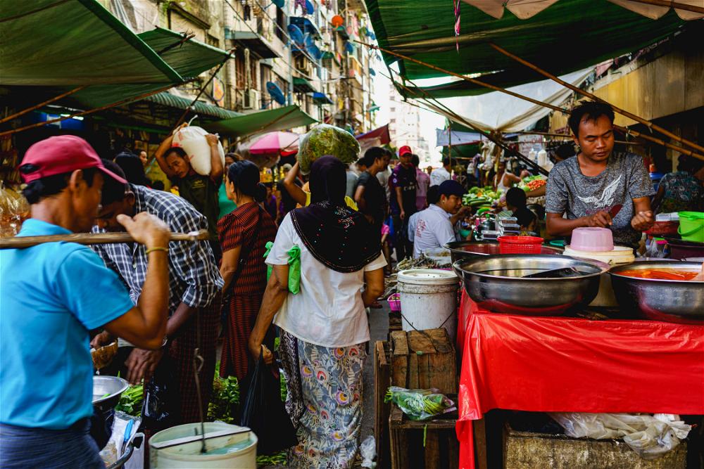 Street market local vendors selling goods and produce in Chinatown Yangon Myanmar Burma