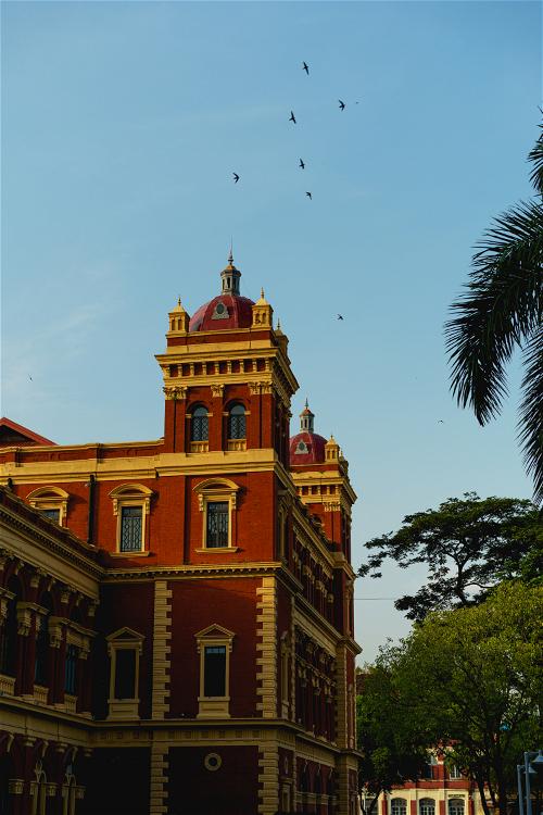 Red and yellow Secretariat building historic landmark in downtown Yangon Myanmar Burma