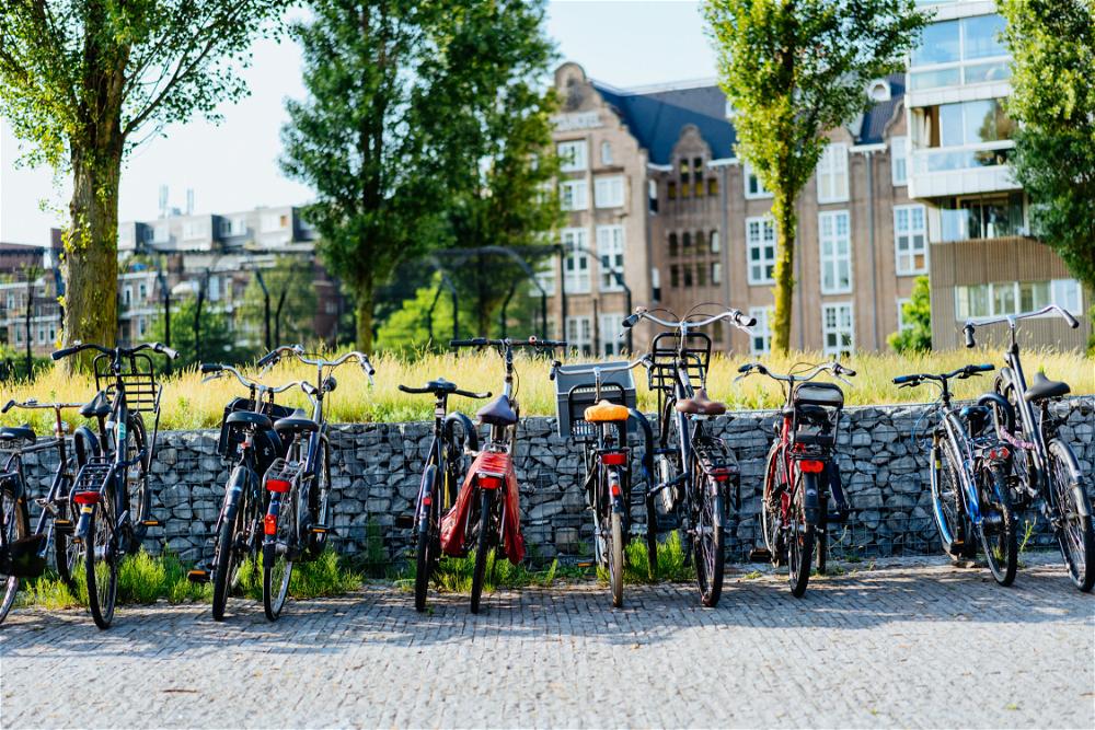 A row of bicycles parked in front of a brick wall in The Netherlands.