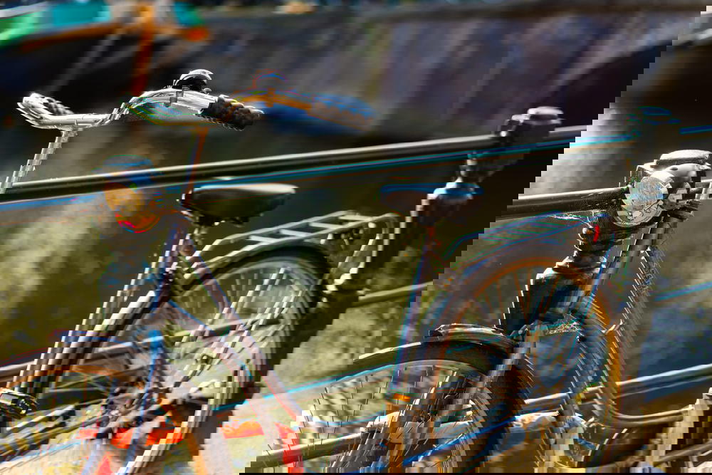 Old bike along a canal railing in Amsterdam