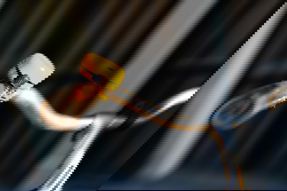 Yellow bike bell on bike handlebars