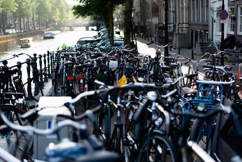 A row of bicycles parked next to a canal in The Netherlands.