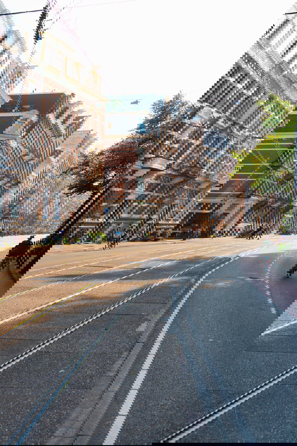 A city street in Amsterdam with distinct Dutch architecture.