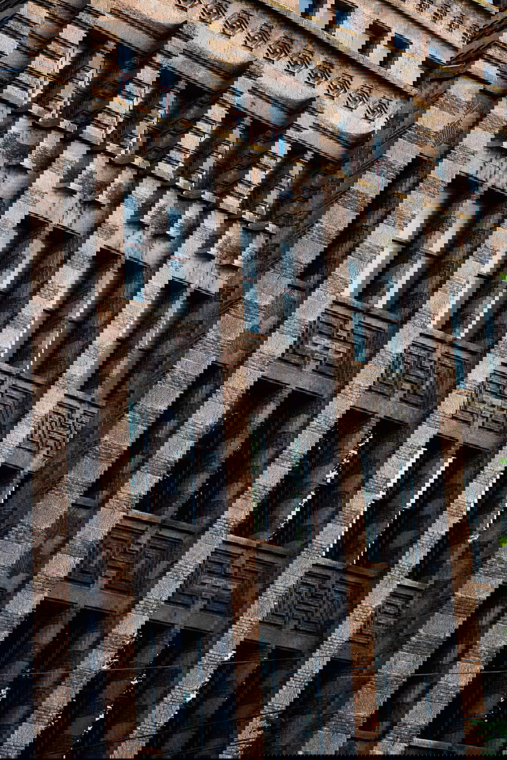 A large architectural masterpiece in Amsterdam, The Netherlands, featuring a clock on its facade.