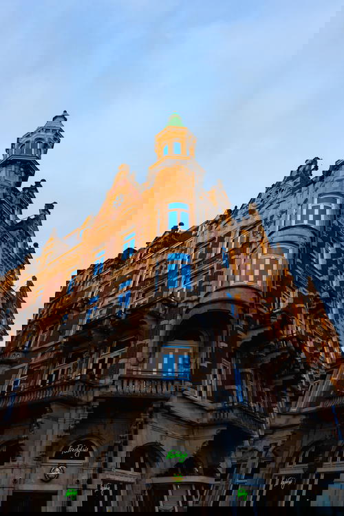 A clock tower in Amsterdam showcasing exquisite Dutch architecture.