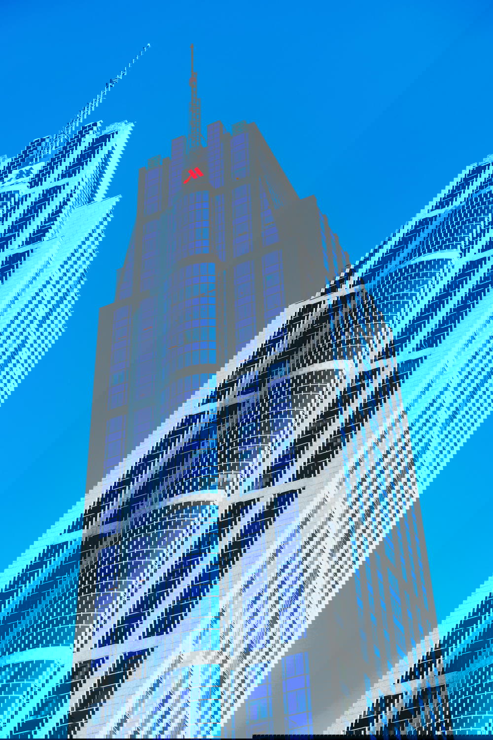 A towering architectural marvel against the blue sky of Rotterdam, The Netherlands.