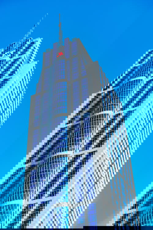 A towering architectural marvel against the blue sky of Rotterdam, The Netherlands.