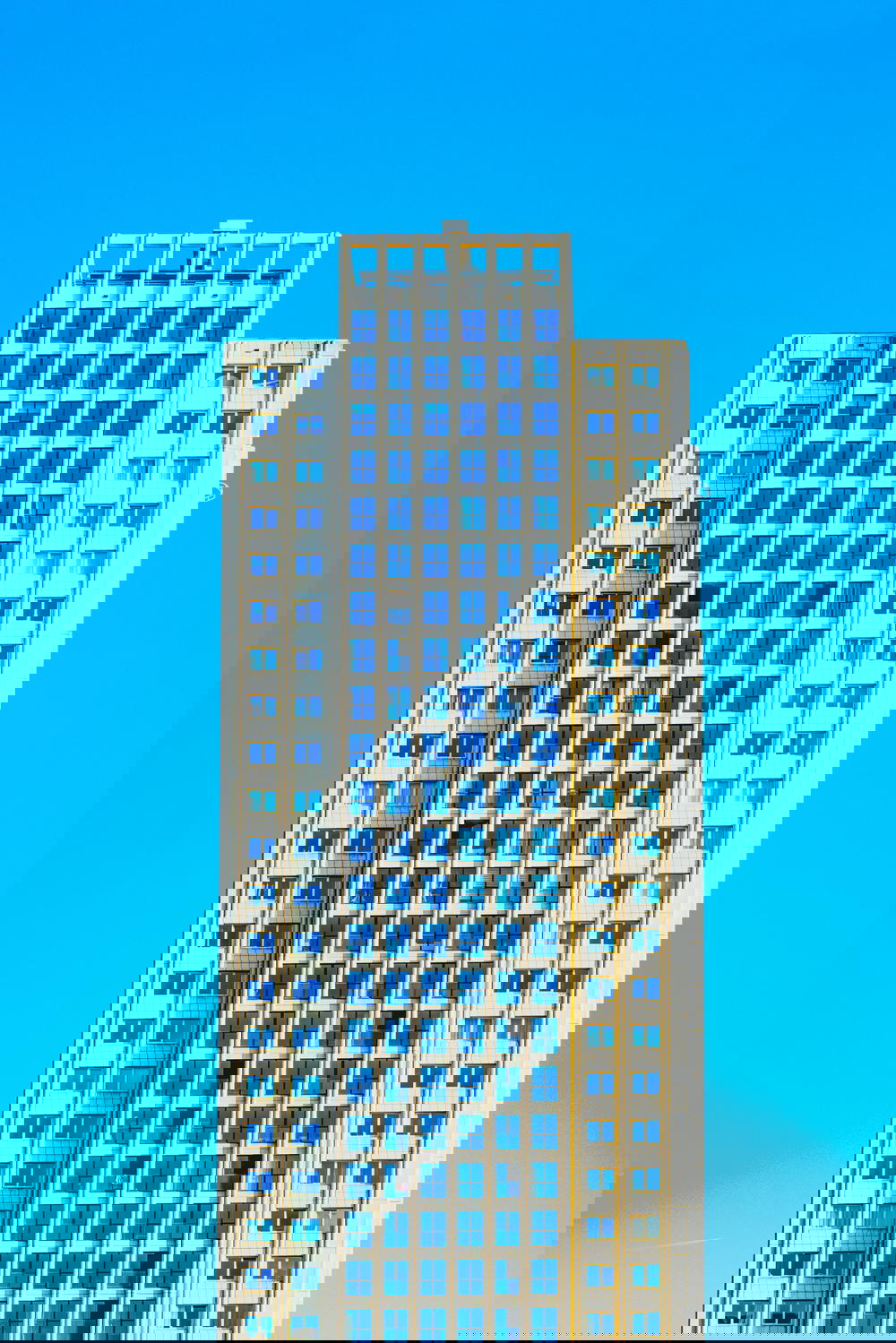 A towering architectural masterpiece in Rotterdam, The Netherlands adorned with countless windows.