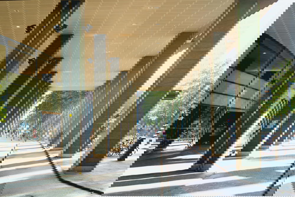 A sidewalk featuring architectural pillars and a bike in Rotterdam, The Netherlands.