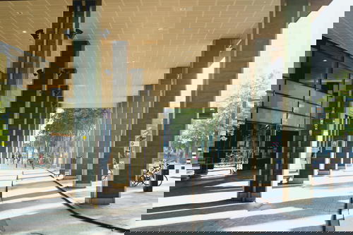 A sidewalk featuring architectural pillars and a bike in Rotterdam, The Netherlands.