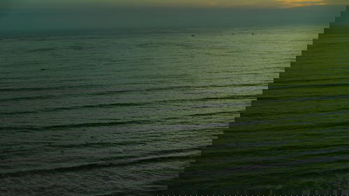 A man is riding a surfboard in Peru.