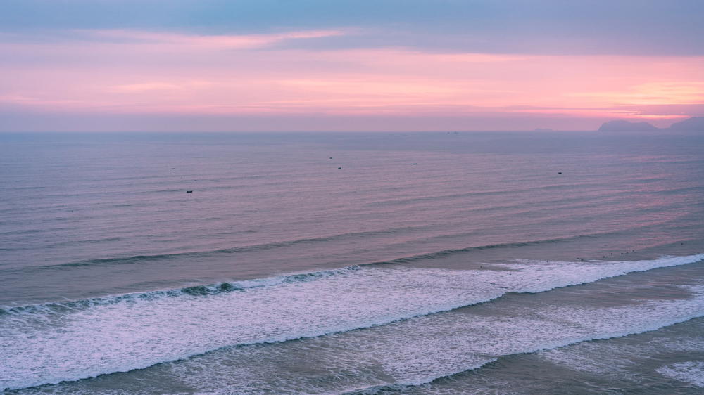 An aerial view of the ocean off the coast of Peru at sunset.