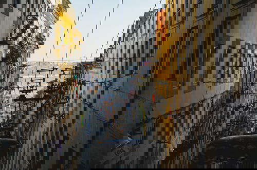 A cable car descending a narrow Lisbon street in Portugal.