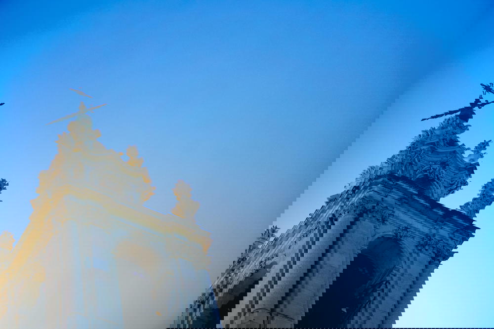 A church tower with a cross in the sky in Portugal.