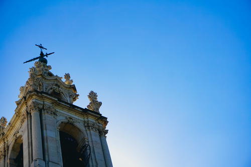 A church tower with a cross in the sky in Portugal.