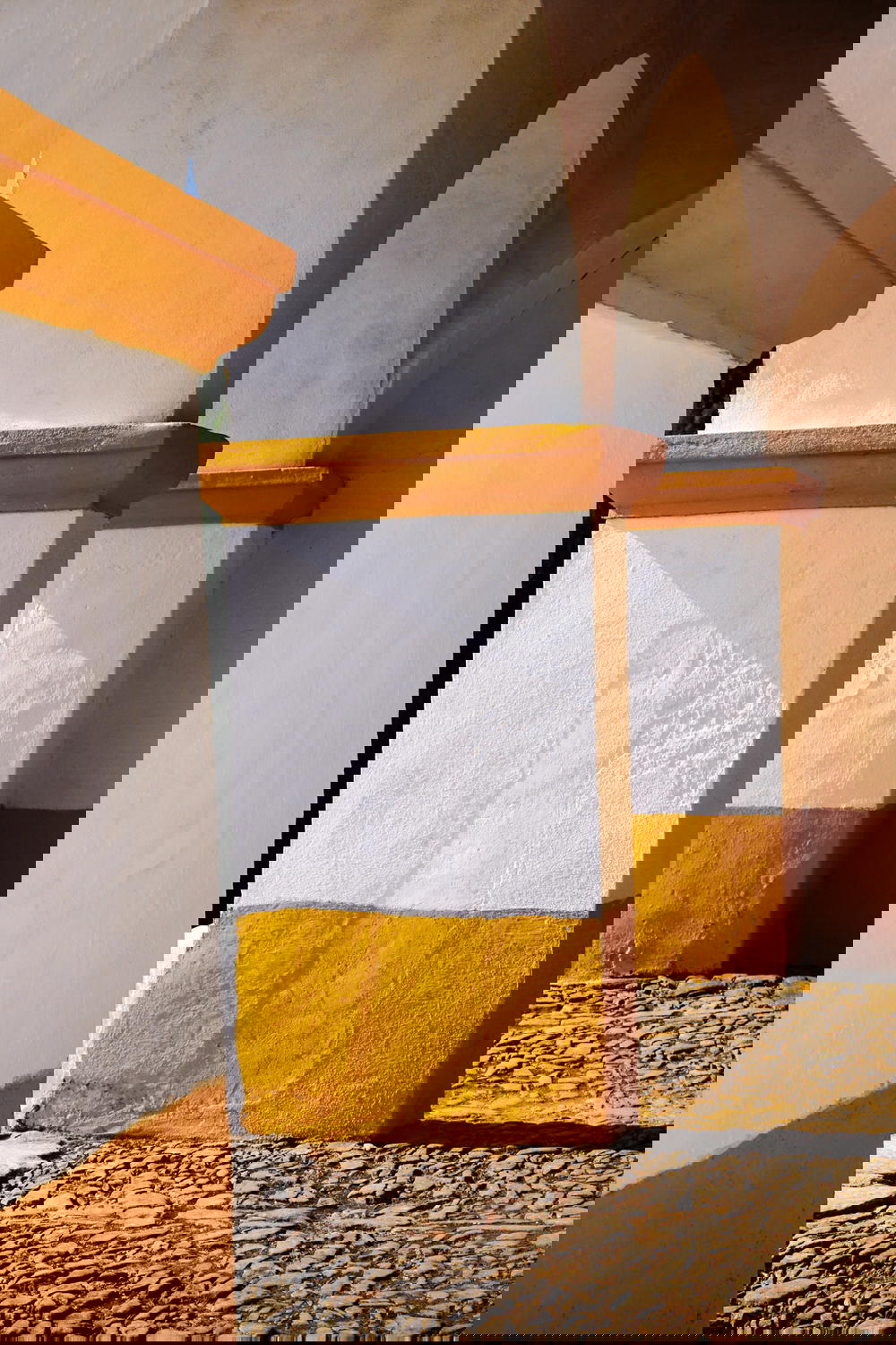 A row of white and yellow painted pillars in Portugal.