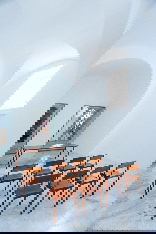 A group of chairs in a room with a white ceiling in Portugal.