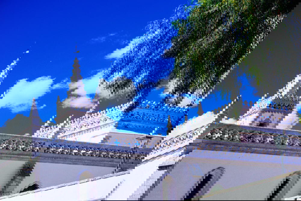 A white building in Portugal with a blue sky.