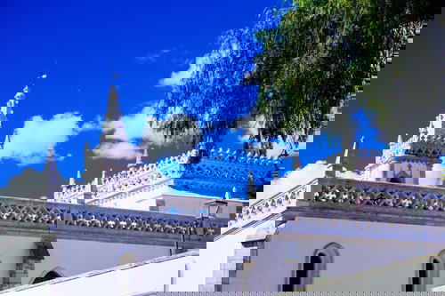 A white building in Portugal with a blue sky.