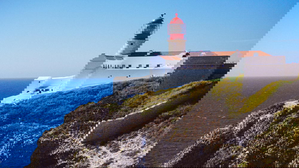 A Portugal lighthouse overlooking the ocean.