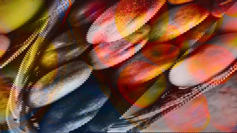 Peaches in baskets on a Portugal table.