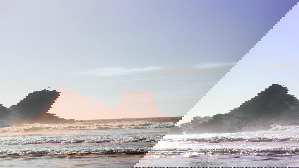 A man is flying a kite on the Portuguese beach.