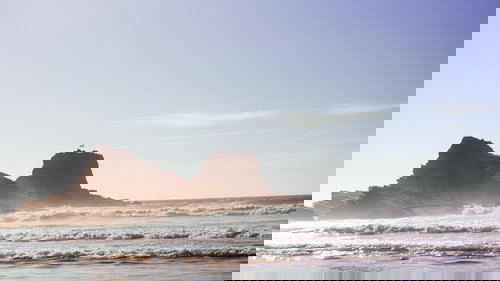 A man is flying a kite on the Portuguese beach.
