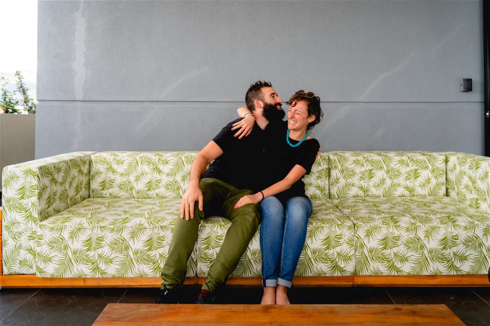 A man and woman sitting on a couch.