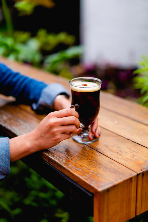 A person holding a cup of coffee.
