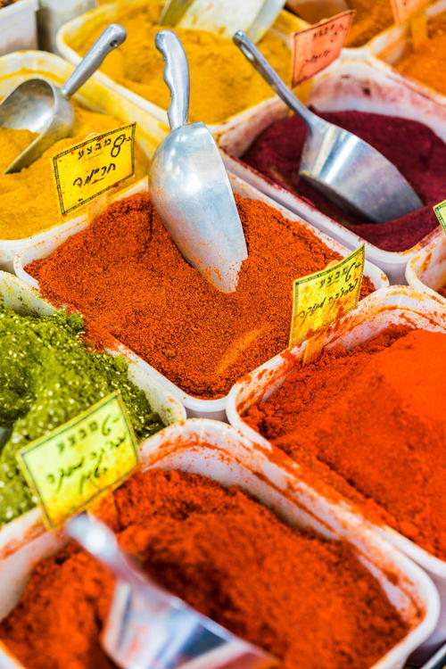 A variety of spices in trays on a table.