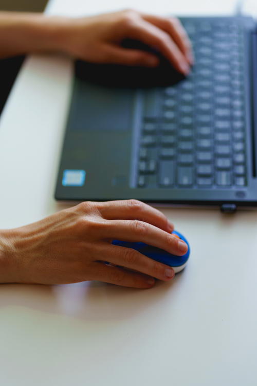 A woman's hands on a keyboard.
