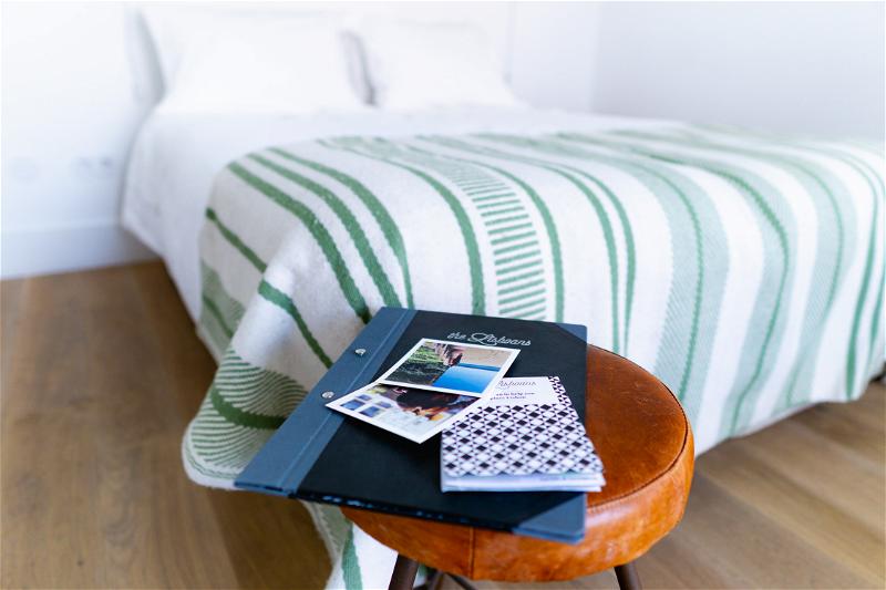 Trendy minimalist hotel room side table with helpful travel books
