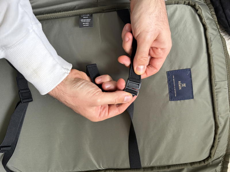 a person showing details of a roark travel bag