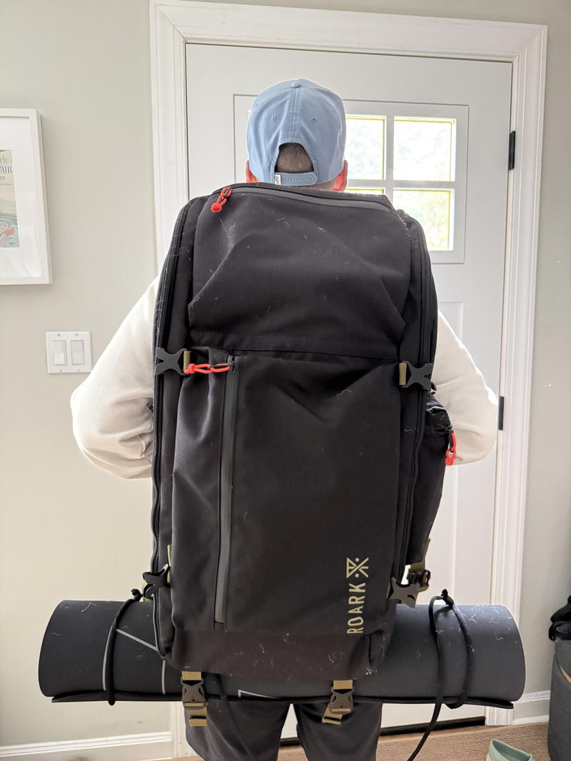 a man standing with a roark bag on his back
