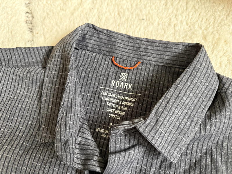 a shirt that is laying on the floor