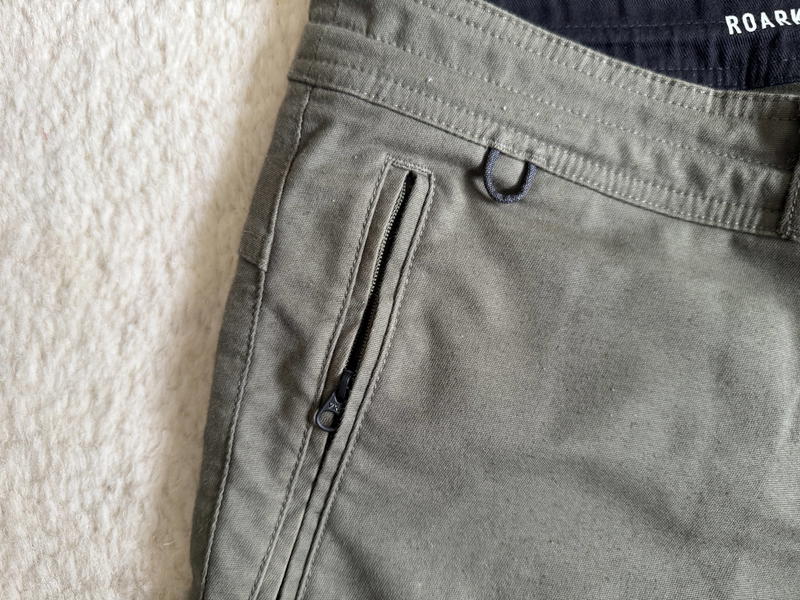 a pair of green pants on a white carpet