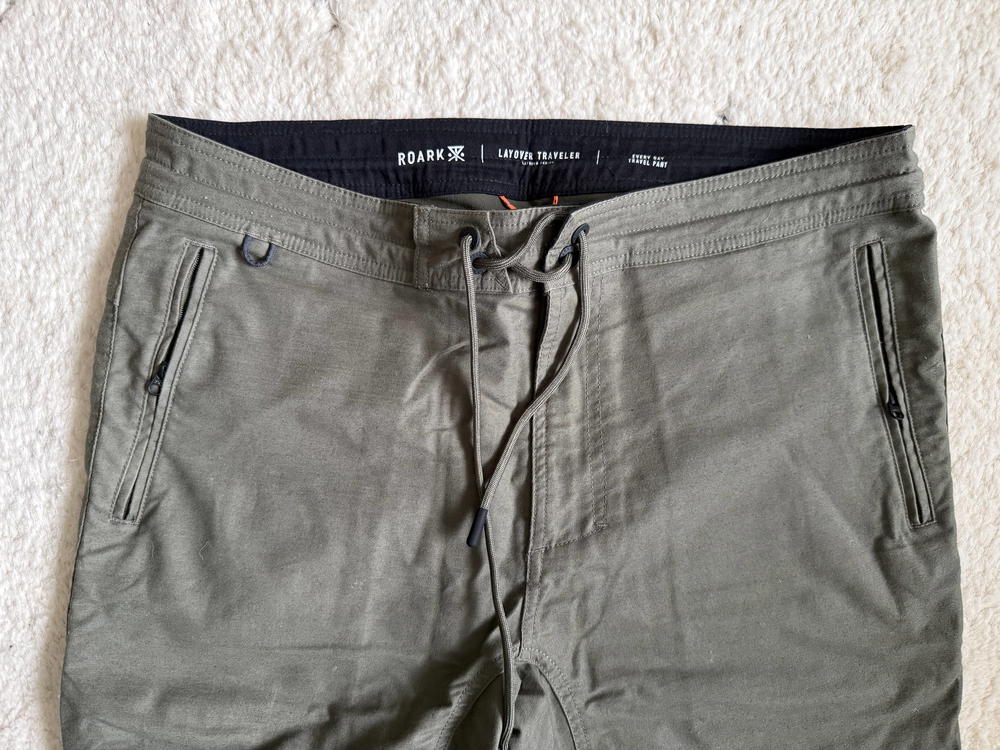 a pair of green pants on a white carpet