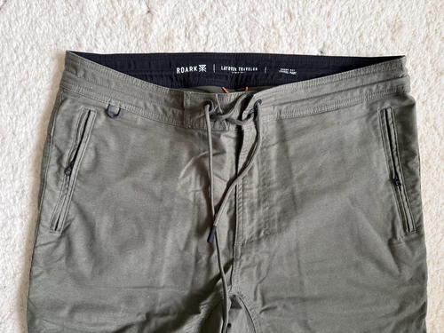 a pair of green pants on a white carpet