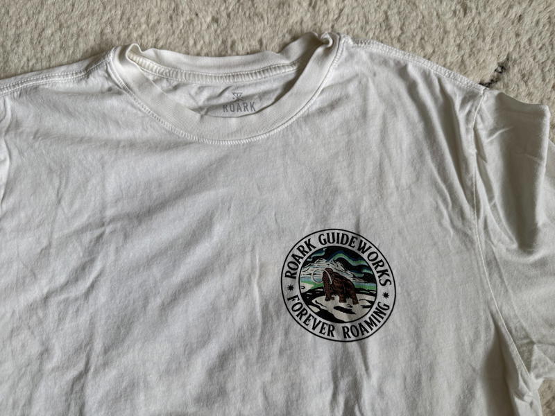 a white t-shirt with a roark logo on it