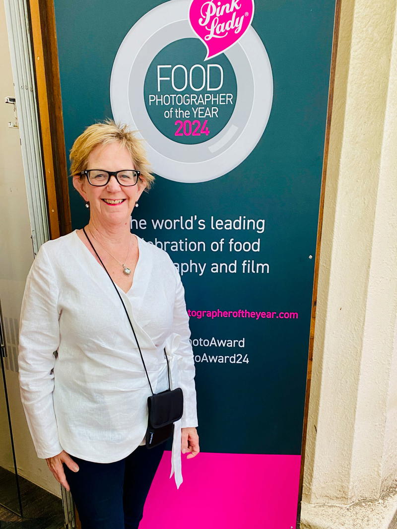 a woman standing in front of a sign