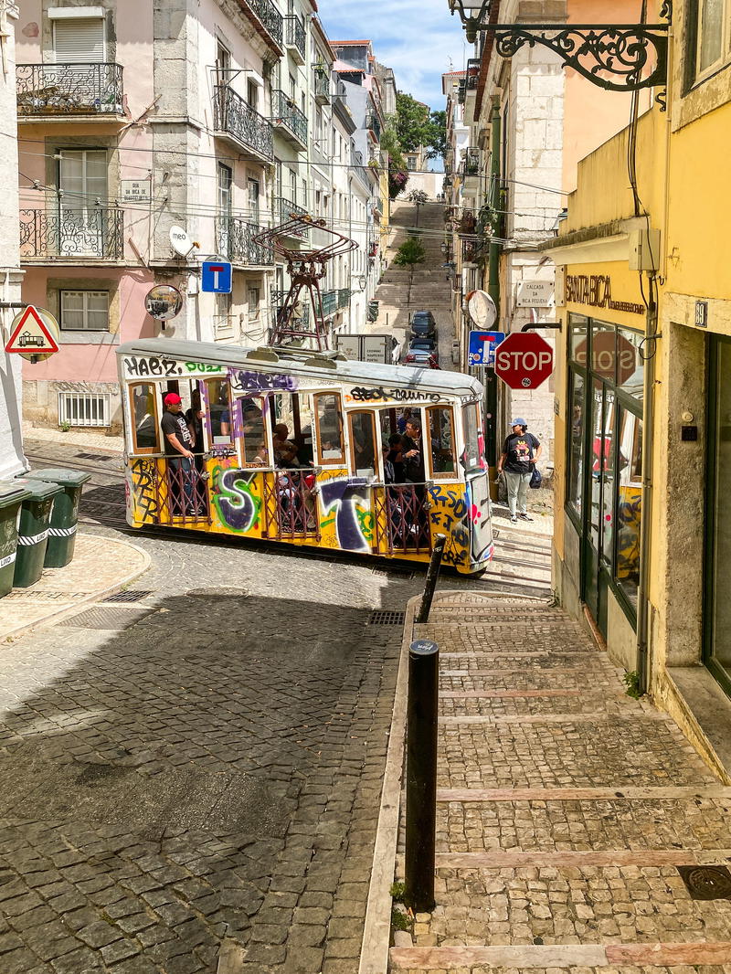 a street scene with a trolley car on the side of the road