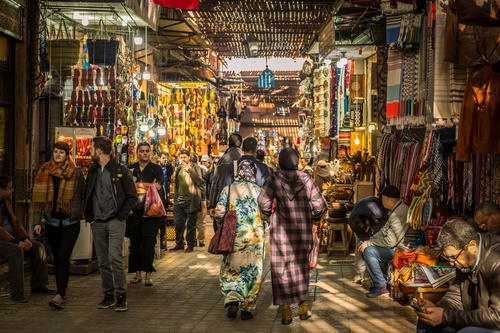 a group of people walking through a market